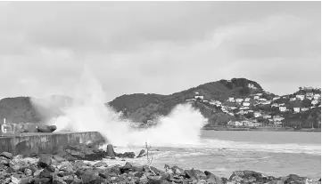  ??  ?? Huge waves lash Lyall Bay in the New Zealand capital of Wellington. Flood-hit regions of New Zealand were warned to expect more wild weather after a deluge forced evacuation­s and emergency declaratio­ns in parts of the South Island. — AFP photo