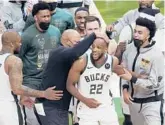  ?? PAUL SANCYA/AP ?? Khris Middleton (22) celebrates with teammates during the Bucks’ 109-103 victory over the Suns in Game 4 of the NBA Finals on Wednesday in Milwaukee.