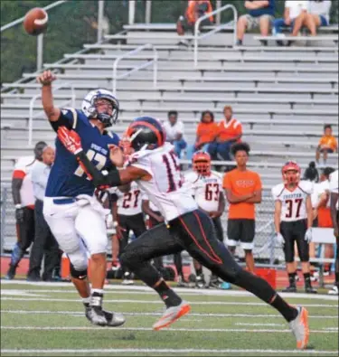  ?? BARRY TAGLIEBER - FOR DIGITAL FIRST MEDIA ?? Above, Spring-Ford’s T.J. Pergine throws a pass over Chester’s Davouge Hopkins Friday. Below, Spring-Ford’s Selwyn Simpson goes around the defense of Chester’s Lamir Crews.