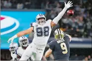  ?? RON JENKINS/AP PHOTO ?? New Orleans Saints quarterbac­k Drew Brees (9) is pressured by Dallas Cowboys defensive tackle Tyrone Crawford (98) during the second half Thursday.