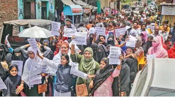  ?? — PTI ?? Congress activists hold a protest against BJP spokespers­on Nupur Sharma for her alleged remarks about Prophet Muhammad, in Kota on Sunday. Sharma was later suspended from the party.