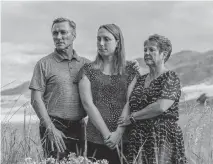  ?? ANDREW MILLER NYT ?? Lilia James, center, stands with her parents Andrew and Debbie James, who are members of Embracing the Journey, a Christian care and counseling group helping families with LGBTQ+ family members navigate issues of faith and family.