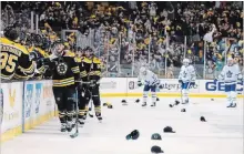  ?? WINSLOW TOWNSON THE ASSOCIATED PRESS ?? Hats litter the ice after David Pastrnak’s third goal Saturday. The Bruins sniper added three assists in a 7-3 whipping of the Leafs in Boston.