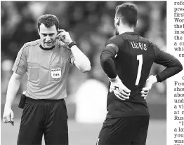  ??  ?? France’s Hugo Lloris (right) talks to referee Felix Zwayer before he awards Spain’s second goal during the internatio­nal friendly match at Stade de France, Saint-Denis near Paris. — Reuters photo