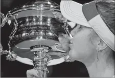  ?? LEE JIN-MAN/AP PHOTO ?? Sofia Kenin of the U.S. kisses the Daphne Akhurst Memorial Cup on Saturday after defeating Spain’s Garbine Muguruza in the women’s singles final at the Australian Open in Melbourne, Australia.