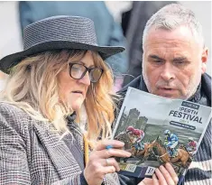  ?? ?? Lucky Racegoers search for a winner