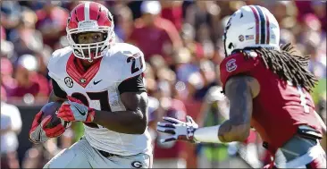  ?? FILE PHOTOS ?? Michigan is peaking at the right time, with three victories in three days at the Big Ten Tournament. The Georgia running back Nick Chubb is scheduled to talk at SEC Media Days on Tuesday, joining Bulldogs coach Kirby Smart, along with fellow running...