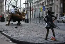  ??  ?? The Fearless Girl statue faces the Charging Bull in Lower Manhattan. It was erected to to honour Internatio­nal Women’s Day.