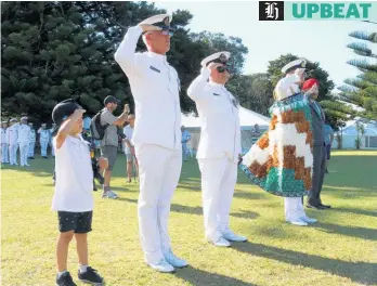  ?? Photo / Peter de Graaf ?? Connor Petersen-Hodge, 5, joins Warrant Officers Joseph Gray (left) and Pete Johnson, Rear Admiral David Proctor and ex-serviceman Hirini Henare in saluting navy sailors as they march from the parade ground.