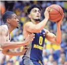  ?? ASSOCIATED PRESS ?? Marquette's Markus Howard drives against VCU guard Malik Crowfield on Monday.