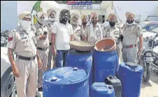 ?? HT PHOTO ?? Police with the liquor recovered from the house of Nirbhai Singh, a confidant of Congress’ Khemkaran MLA, on Monday.