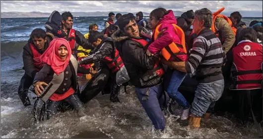  ??  ?? Clockwise from above: Afghan migrants clamber from a boat; rescuers check a toddler’s condition; a volunteer holds a baby plucked from the chilly sea.