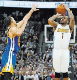  ?? DAVID ZALUBOWSKI/ THE ASSOCIATED PRESS ?? Denver guard Jameer Nelson, right, takes a three-point shot over Golden State guard Stephen Curry on Monday in Denver. The Nuggets tied an NBA record with 24 made 3-pointers and won 132-110.