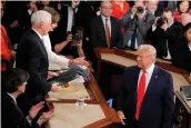  ?? — AP ?? President Donald Trump snubs House Speaker Nancy Pelosi’s move to shake his hand after he handed her a copy his State of the Union address during the joint session of Congress on Capitol Hill in Washington.