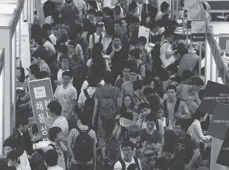  ?? SEONGJOON CHO/BLOOMBERG ?? College students attend a job fair at Hanyang University in Seoul. With youth, even college graduates, feeling excluded from careers, President Moon Jaein has vowed to stop discrimina­tory practices as part of his fight against growing inequality in the...