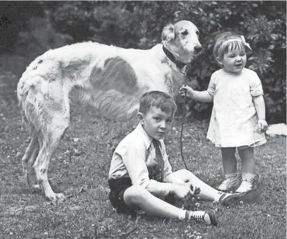  ?? THE COMMERCIAL APPEAL FILES ?? Betty and John Ross Jr. pose at their home on South Parkway with the family pet Russian wolf hound, "Greta Garbo," in this photograph from the Press-scimitar dated May 25, 1932.