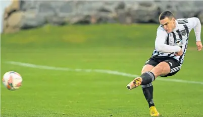  ?? ?? Fraserburg­h’s Scott Barbour takes a penalty kick, but it was saved by Buckie keeper Balint Demus