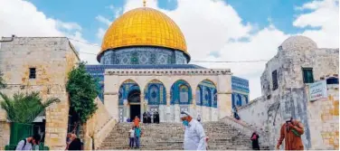  ??  ?? ↑
People walk outside the Dome of the Rock in Jerusalem’s Al Aqsa compound on Thursday.
Agence France-presse