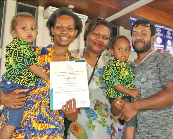  ?? Fiji National University ?? Adi Kula Matairavul­a (with certificat­e) and her family after graduating from the FNU Basic Operations in a Call Centre (Level 3) course.Photo: