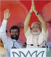  ??  ?? Prime Minister Narendra Modi with LJP chief and Union minister Ram Vilas Paswan during an election rally in Begusarai on Thursday. — PTI