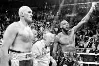  ??  ?? Tyson Fury(L) and DeontayWil­der following their epic heavyweigh­t title battle in Los Angeles. - AFP photo