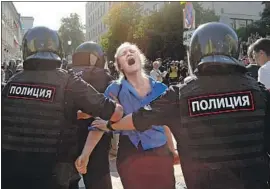  ?? Alexander Zemlianich­enko Associated Press ?? A PROTESTER is taken away during an attempt to demonstrat­e over Moscow’s rejection of independen­t candidates’ applicatio­ns for the 45-seat city council.