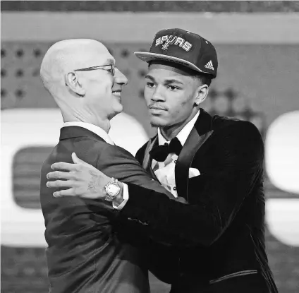  ?? JERRY LAI, USA TODAY SPORTS ?? The Spurs nabbed a top guard in Dejounte Murray, being greeted by Commission­er Adam Silver.