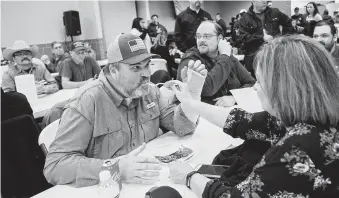  ?? Marie D. De Jesús / Staff photograph­er ?? Sandra Hensley helps her husband, Capt. Wesley Hensley, during a Harris County Sheriff's Office union BBQ benefit on Friday. Hensley was shot nine times and is facing a long recovery.