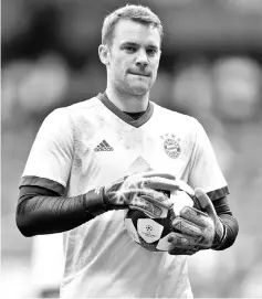  ??  ?? (FILES) This file photo taken on April 18, 2017 shows Bayern Munich’s goalkeeper Manuel Neuer holding a ball prior the UEFA Champions League quarter-final second leg football match Real Madrid vs FC Bayern Munich at the Santiago Bernabeu stadium in...