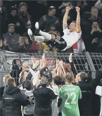  ?? PICTURE: NICK POTTS/PA ?? GOING OUT ON A HIGH: Germany’s Lukas Podolski celebrates with team-mates after his final game following the internatio­nal friendly win over England at Signal Iduna Park, Dortmund. The striker scored the winner, his 49th internatio­nal goal.