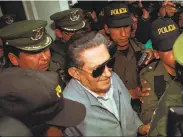  ?? Sandra Boulanger / Associated Press 1997 ?? Bolivia’s jailed, ex-dictator Luis Garcia Meza is surrounded by police as he leaves a hospital in 1997.