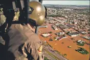  ?? ?? A military member observes from a helicopter the flooded streets of El Dorado do Sul city, Rio Grande do Sul state, Brazil.