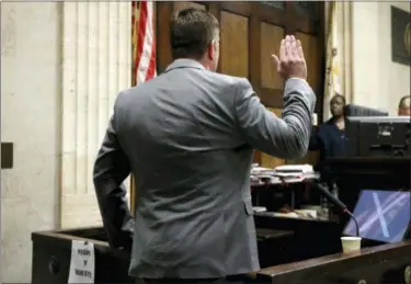  ?? ANTONIO PEREZ — CHICAGO TRIBUNE VIA AP ?? Chicago police Officer Jason Van Dyke is sworn in before taking the stand in his murder trial Tuesday for the shooting death of Laquan McDonald, in Chicago.