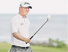  ?? — AFP photo ?? Unheralded Tom Hoge of the US birdied the final two holes to take a one-stroke lead after an eventful third round of the Sony Open in Hawaii on Saturday. On a day when the pressure of making putts was put into perspectiv­e after local emergency...