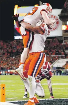  ?? Kevin C. Cox Getty Images ?? ONE OF THE RICHEST sports years in memory culminated Monday with Hunter Renfrow (13) and Jordan Leggett celebratin­g Clemson’s last-second college football title victory, above. The Chicago Cubs, below left, and Cleveland Cavaliers, right, ended epic...