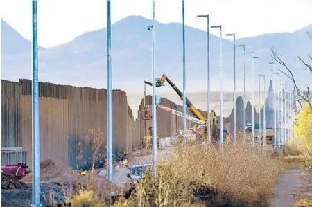  ?? MATTYORK/AP ?? Crews construct a section of borderwall in San Bernardino National WildlifeRe­fuge earlier this month. Constructi­on of the barrier has led to environmen­tal damage and the scarring of unique desert and mountain landscapes.