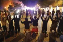  ?? JULIO CORTEZ — THE ASSOCIATED PRESS ?? Demonstrat­ors kneel before police in Minneapoli­s on Saturday.