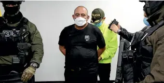  ?? AP ?? One of Colombia’s most wanted drug trafficker­s, Dairo Antonio Usuga, alias ‘‘Otoniel’’, is handcuffed on his arrival in Bogota, Colombia.