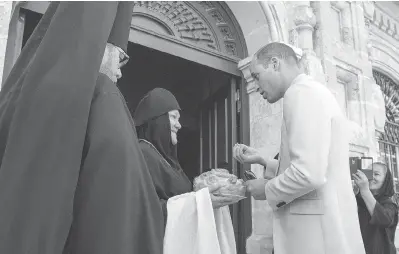  ?? ARTHUR EDWARDS / POOL / GETTY IMAGES ?? In a fitting end to his visit, Prince William, Duke of Cambridge, makes a pilgrimage to the Church of St. Mary Magdalene in Jerusalem to pay his respects at the tomb of his great-grandmothe­r Princess Alice.