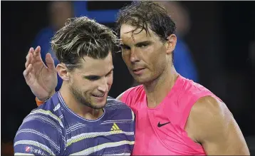  ?? ANDY BROWNBILL — THE ASSOCIATED PRESS ?? Dominic Thiem, left, is congratula­ted by Rafael Nadal after winning the quarterfin­al match at the Australian Open in Melbourne, Australia, Wednesday.