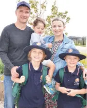  ??  ?? New students Oliver and Luka Fak (front) say goodbye to parents Dean and Marijana and little brother Charlie on their first day at St Angela of the Cross primary school.