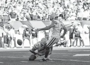  ?? Dylan Buell / Getty Images ?? After missing three straight field goal attempts, Mason Crosby kicks a 49-yard game-winning field late in overtime to help Green Bay escape Cincinnati with a 25-22 win Sunday afternoon