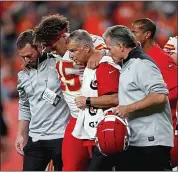  ?? MATTHEW STOCKMAN — GETTY IMAGES ?? Chiefs quarterbac­k Patrick Mahomes is helped off the field after suffering a right knee injuring against the Broncos.