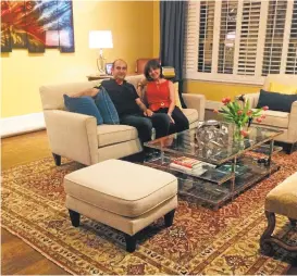  ?? COURTESY MARNI JAMESON ?? Rug merchant Hakan Zor, left, with Marni Jameson in her Florida great room, transforme­d by the hand-knotted wool rug he delivered from Turkey.