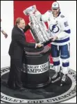  ?? The Canadian Press via AP ?? TROPHY — Tampa Bay Lightning’s Steven Stamkos (91) is presented the Stanley Cup from NHL commission­er Gary Bettman as they celebrate after defeating the Dallas Stars in the NHL Stanley Cup hockey finals, in Edmonton, Alberta, on Monday.