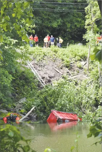  ?? Kendra Baker / Hearst Connecticu­t Media ?? A driver was killed and another was injured on Tuesday in a crash that sent a dump truck into the Housatonic River in New Milford.