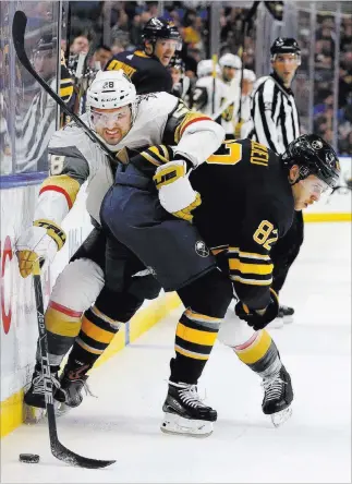  ?? Jeffrey T. Barnes ?? The Associated Press Golden Knights left wing William Carrier gets checked into the boards by Sabres defenseman Nathan Beaulieu (82) in the first period of a 4-2 Buffalo victory Monday at Keybank Center in Buffalo N.Y.