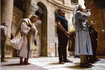  ?? Alexi J. Rosenfeld/Getty Images ?? Carl James Joseph, dressed as Jesus, prays the the Church of the Holy Sepulchre on Good Friday in Jerusalem.