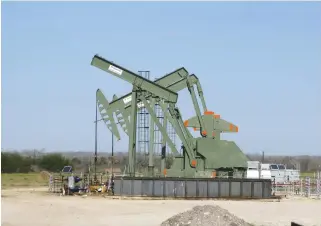  ??  ?? A crude oil well in South Texas. US shale oil output is set to surge over the next five years according to the IEA, as US producers eat into the market share of their OPEC rivals. (Reuters)