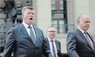  ?? CHIP SOMODEVILL­A GETTY IMAGES ?? Kevin Downing, left, Brian Ketcham and Thomas Zehnle, lawyers for former Trump campaign chairman Paul Manafort, leave the courthouse in Alexandria, Virginia, on Friday.